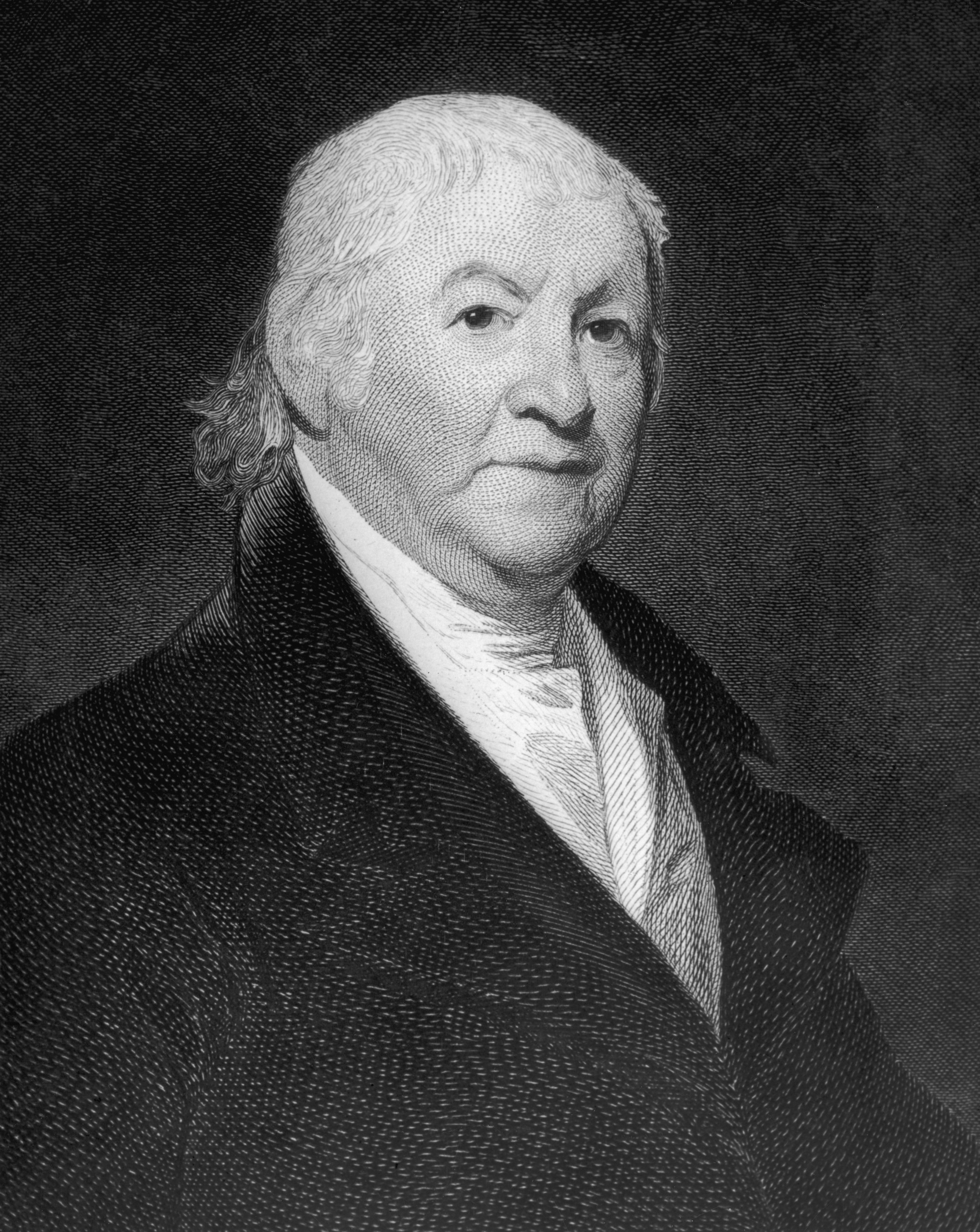 black and white portrait of an older man shown wearing a dark coat and a light collared shirt
