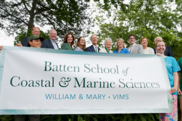 A group of people hold a sign that says Batten School of Coastal & Marine Sciences.