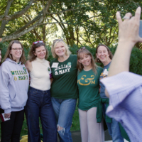 A group of people smile while posting for a photo together.