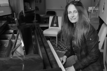 Sophia Serghi sits at a piano.
