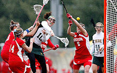 Women's Lacrosse players scoring a goal