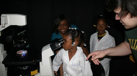 Student looking through microscope