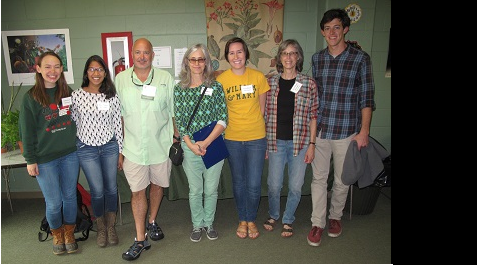 A group photo including staff, volunteers, and alumni