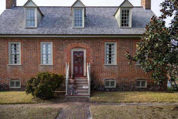 Faith Page sitting in front of the house where she developed a historical tour in December. (photo by Tess Willett)