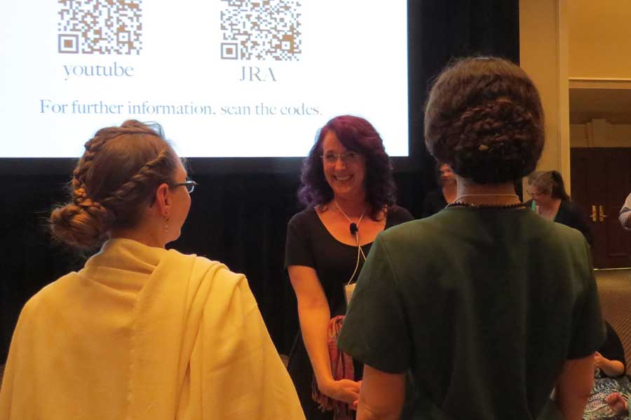 Professor Irby and an attendee sporting ancient hairsyles, both done by Janet Stephens