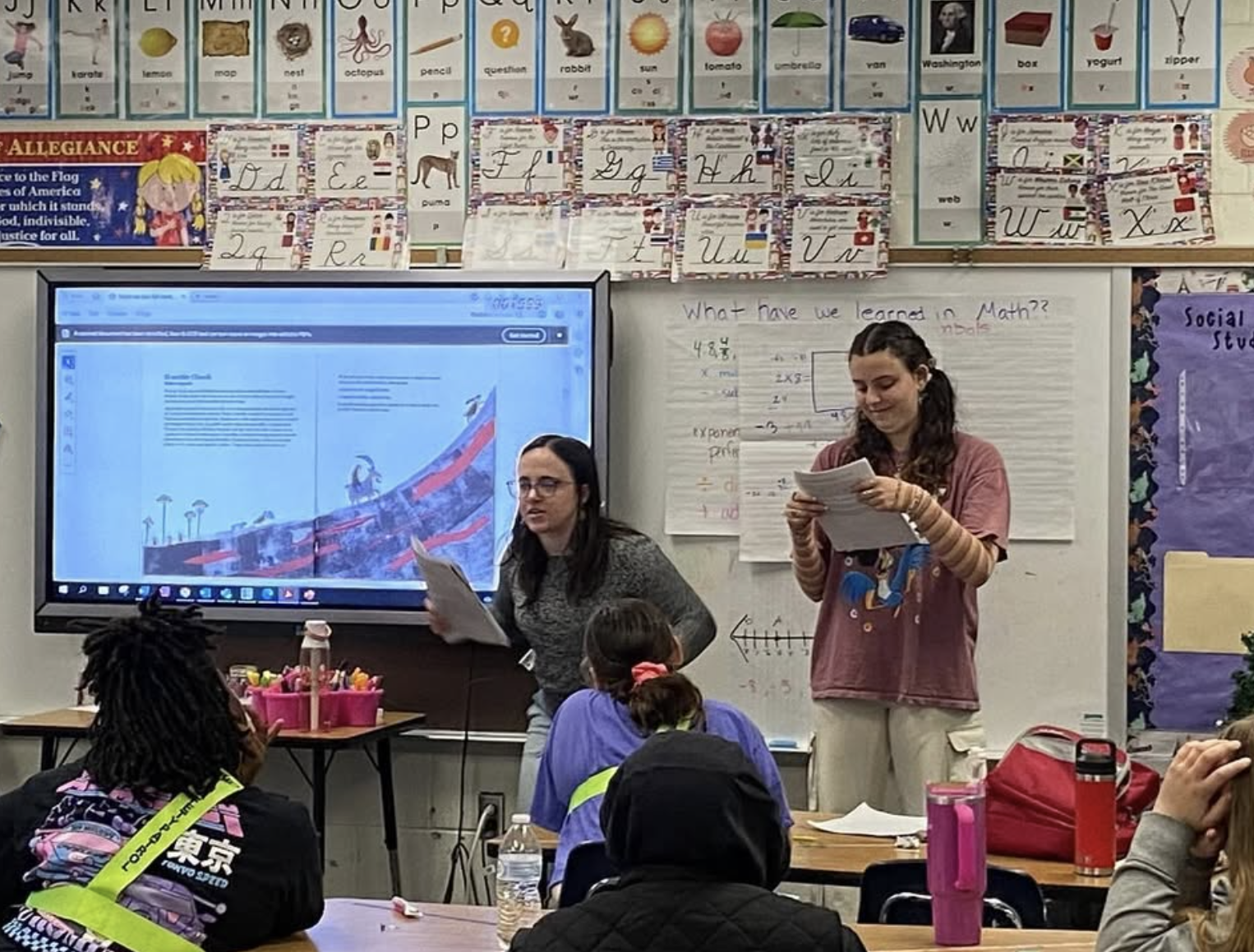 HISP majors Katy Callicott and Grace Cohen read "El terrible Cherufe," a Mapuche story, to Charles City Elementary students