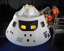 NASA astronauts step into the Orion crew module hatch during a series of spacesuit tests conducted in 2013. The module will serve as both transport and a home for astronauts during future long-duration missions. Photo by NASA/Bill Stafford