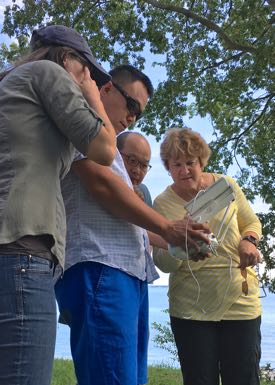 From left: VIMS Ph.D. student Lydia Bienlien works with professors Donglai Gong, BK Song, and Kim Reece to control the drone in flight. (Photo by D. Malmquist/VIMS)