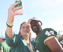 W&M Athletics Director Samantha Huge takes a photo with Warren Winston '72. (Photo by Stephen Salpukas)