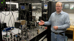Eugeniy Mikhailov discusses his role in the LIGO experiment in his Small Hall laboratory.  (Photo by Joseph McClain)