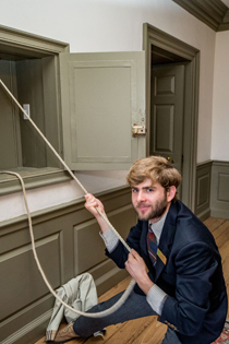 Robert Watkins '18 rings the Wren Bell Tuesday morning to announce the selection of W&M's 28th president. Watkins and sophomores Spencer Gilbert and Adam Kearney rang the bell a total of 28 times. (Photo by Skip Rowland '83)