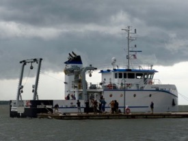 Photographers catch the action as First Lady Pam Northam christens the RV Virginia under a stormy sky. (Photo by D. Malmquist/VIMS)
