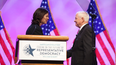 Katherine Rowe shakes Robert Gates' hand on stage