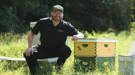 Stephen Moyer with box containing honey bees
