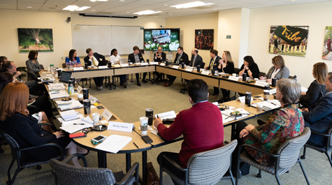 Members of the board sit around tables arranged in a rectangle