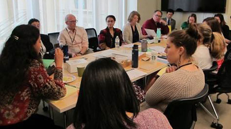 Group of people sitting around conference table