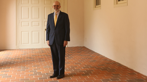 Outgoing Provost Michael R. Halleran stands in the portico of W&M's Wren Building.