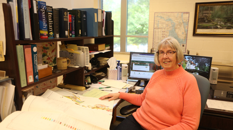 Kathryn Blue sits at her desk