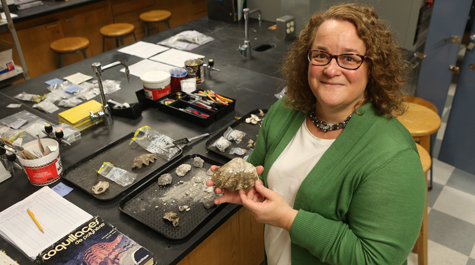 William & 玛丽 archaeologist Jennifer Kahn examines artifacts from one of her numerous excavations of human sites in the islands of Oceania.