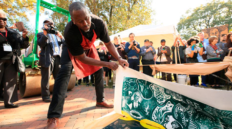 Steve Prince peels paper back from woodcut block
