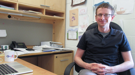 Physicist Justin Stevens is pictured sitting in his office at Small Hall at William & 玛丽