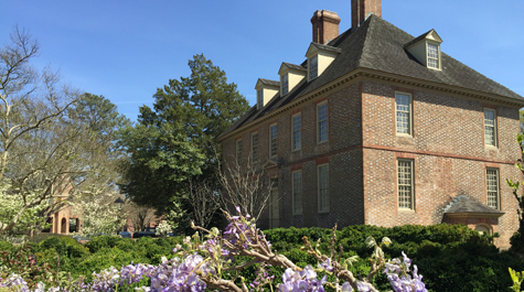 Wisteria grows on a fence in front of the President's House
