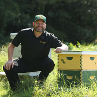 Stephen Moyer with box containing honey bees