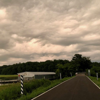 Rain clouds gather over a body of water