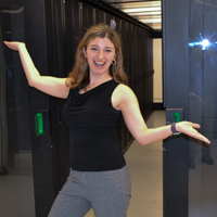 Rachel Oberman stands inside the server room of William & 玛丽’s High Performance Computing cluster.