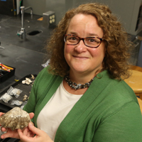 William & 玛丽 archaeologist Jennifer Kahn examines artifacts from one of her numerous excavations of human sites in the islands of Oceania.