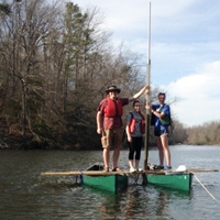 geologist Jim Kaste works with a couple of William & 玛丽 undergraduates from a coring platform assembled from a couple of lashed-together canoes on Lake Matoaka.
