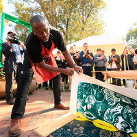 Steve Prince peels paper back from woodcut block