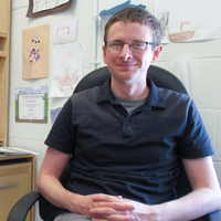 Physicist Justin Stevens is pictured sitting in his office at Small Hall at William & 玛丽
