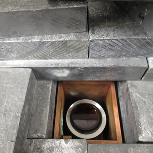 A honey-laden petri sits atop a gamma detector, shielded by a lot of lead ingots. (Photo by Joseph McClain)