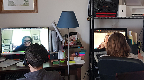 Two students taking a class on their laptops