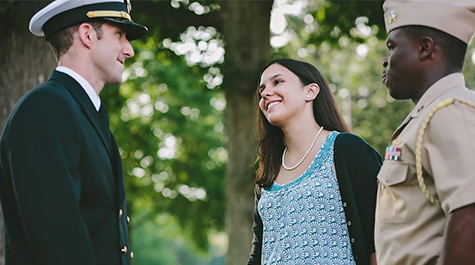 Members of the military in uniform in conversation outdoors