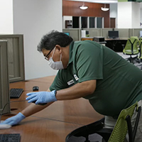 Staff clean desks at Swem library