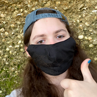 Researcher gives a thumbs up while working at a cliff 