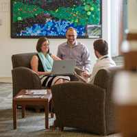 Mark Hofer and two colleagues sitting and talking