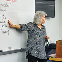 Carlene Klein shows a whiteboard to her students in China