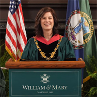 Katherine Rowe in academic regalia standing at a podium