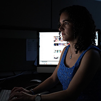 Jaime Settle sitting at a computer 