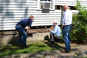 Colonial Williamsburg President and CEO Cliff Fleet, Executive Director of Architectural Preservation Matt Webster, and Vice President for Museums, Preservation and Historic Resources Ron Hurst discuss framing of the Bray-Digges House in 2020. 