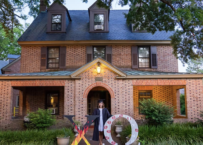 Emma Groene ’20, a Chi Omega member and government major with a concentration in international studies, is shown in front of the sorority house after her graduation. (Courtesy of Chi Omega's Facebook page)