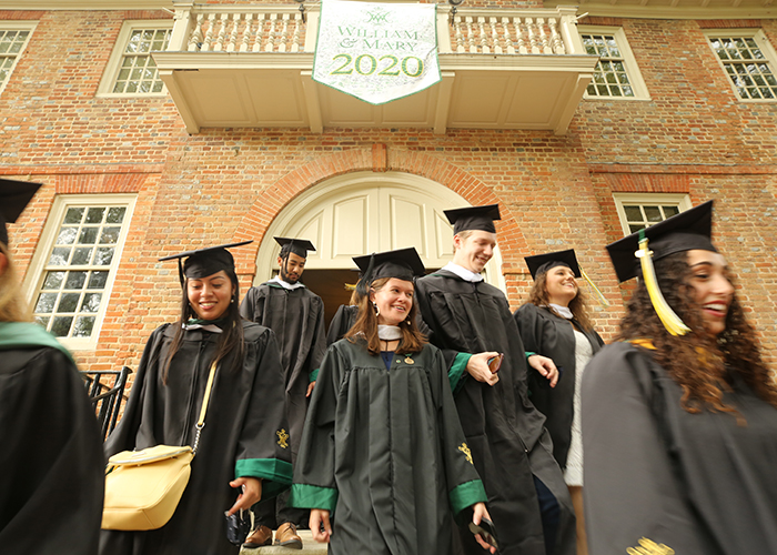 Students from the Class of 2020 pass through the Wren building on their walk across campus. (Photo by Stephen Salpukas) 
