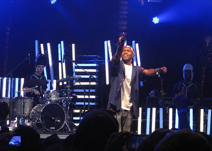 Frank Ocean holds out his microphone to the crowd while performing at Coachella in 2012. (Photo by David Hwang/Creative Commons)