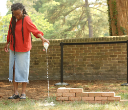 Hermine Pinson presents a libation during the event. (Photo by Stephen Salpukas)