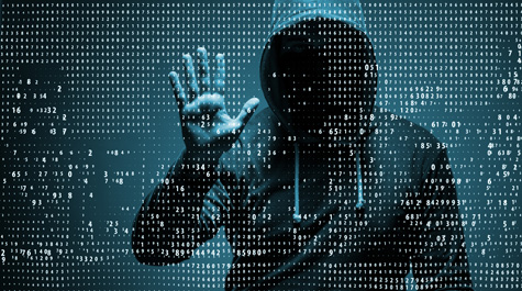 A person whose face can't be seen stands behind a wall of numbers with their hand raised