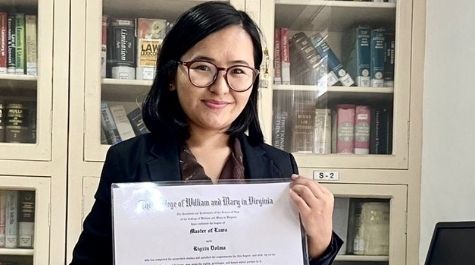 Rigzin Dolma holds up a diploma