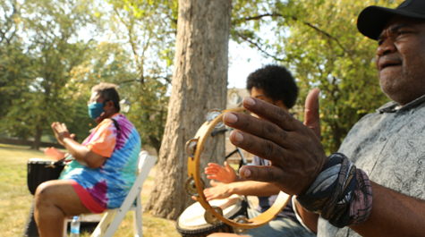 People play musical instruments in an outdoor location